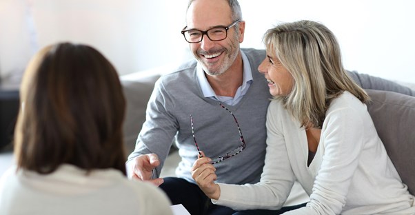An older couple goes over some paperwork with a life coach