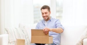A man excitedly opening a gift