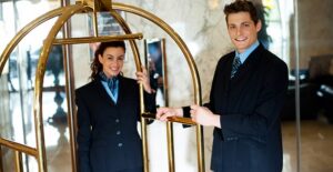 Hospitality managers play in a luggage cart
