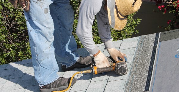 A man replacing his roof on his own