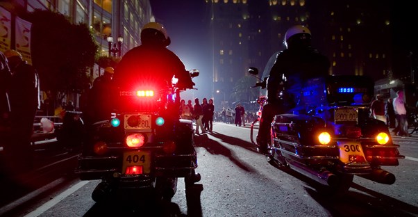 Police officers ride on motorcycles
