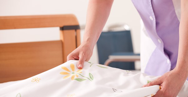 Woman cleans her kid's bed