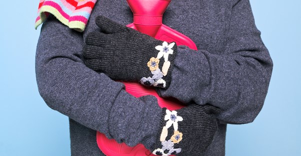 Man trying to keep warm when his heater is broken