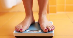 A celebrity weighing herself for her weight loss program
