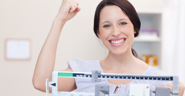 Woman celebrates after her weight loss plan begins to pay off