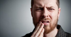 a man who is asking is chewing ice bad for your teeth