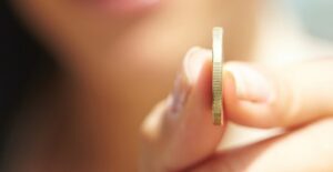 Person holding a coin