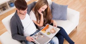 A couple discusses the photos in their photo book