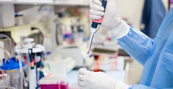 a lab technician who knows the four reasons to undergo genetic testing