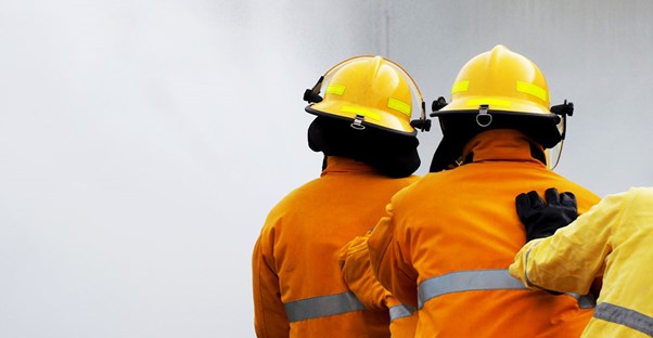 A firefighter sprays water on a fire