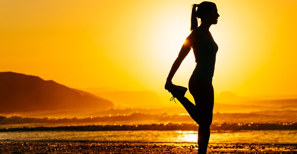 Woman stretching on her morning run.