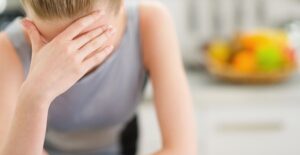 Woman in need of a migraine home remedy.