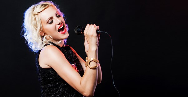 Woman singing on a stage.