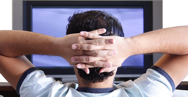 Guy bingeing on a tv show.