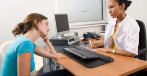 a woman discussing her anorexia with a doctor