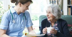Elderly woman talking to an assisted living employee.