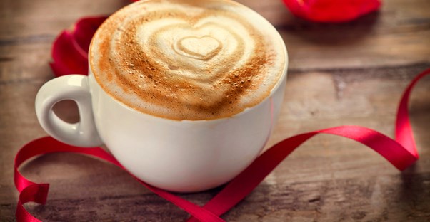 A cup of coffee with a heart drawn in the foam.