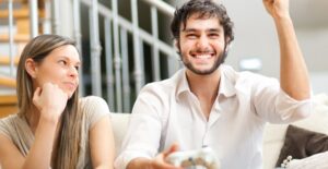 Girl rolls her eyes while her boyfriend plays video games