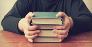 Person looking at self-published books