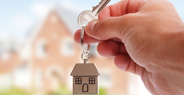 Person holding the key to their home that they are selling by themselves