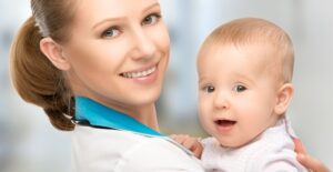 A pediatrician holds a baby