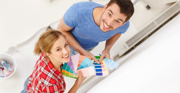 A couple planning out how to decorate their home like an interior designer.