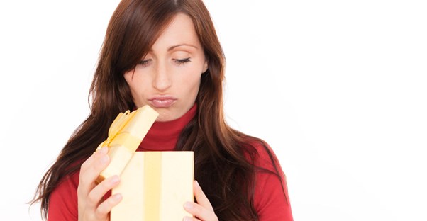 A woman frowning as she opens her subscription box order.