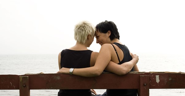 A gay couple embracing.