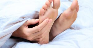 a woman experiencing foot pain from shoes