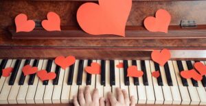 A piano covered in paper hearts for Valentine's Day.