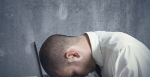 a man struggling from frequent headaches