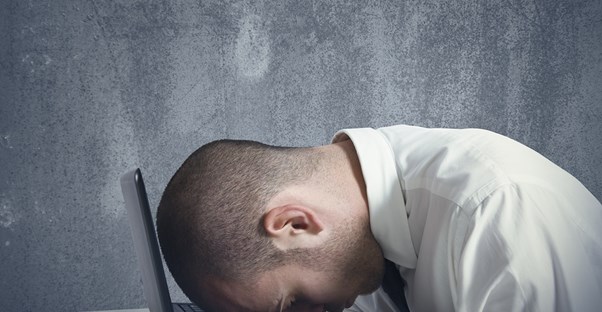 a man struggling from frequent headaches