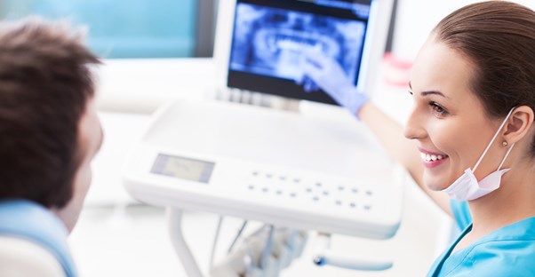 a dentist explaining wisdom teeth terms