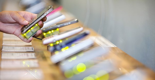 Person testing out different cell phones