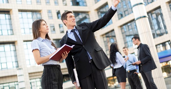 A man and woman discussing a career as a secretary.