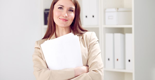 An administrative assistant smiling.