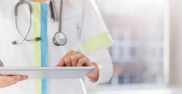 a woman looking at a list of cancer symptoms and signs