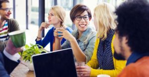 A group of coworkers talk over coffee