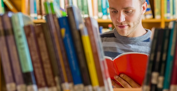 A man reading Lois Lowry