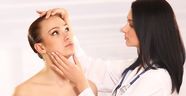 a dermatologist examining a patient's vitiligo