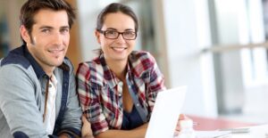 Couple looking into online business schools
