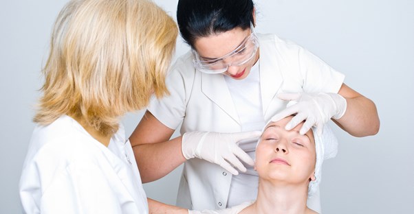 dermatologists examining a patient
