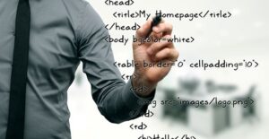 Computer scientist writing HTML code on a white board.