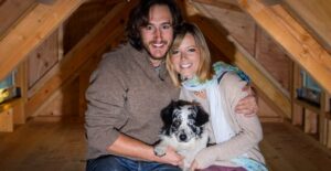 Jenna, Guilaume, and Salies sit in the loft of their tiny home