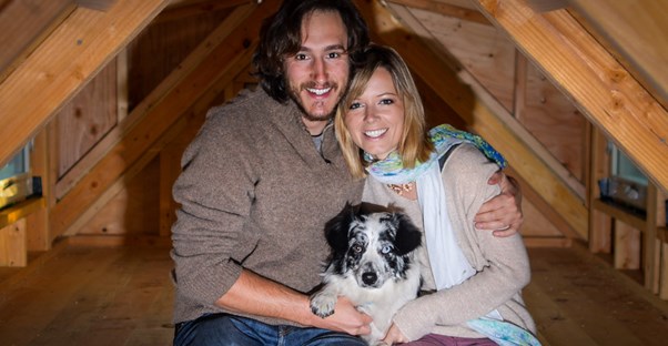 Jenna, Guilaume, and Salies sit in the loft of their tiny home