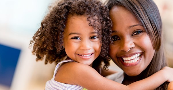 A little girl hugging her mom.