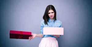 A young mother opening a bad present