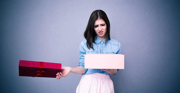 A young mother opening a bad present