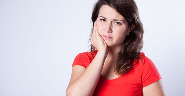 a woman suffering from a canker sore
