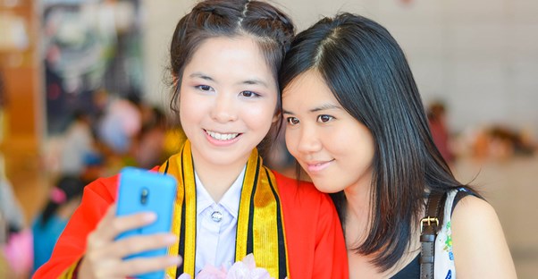 Two girls take a selfie on graduation day